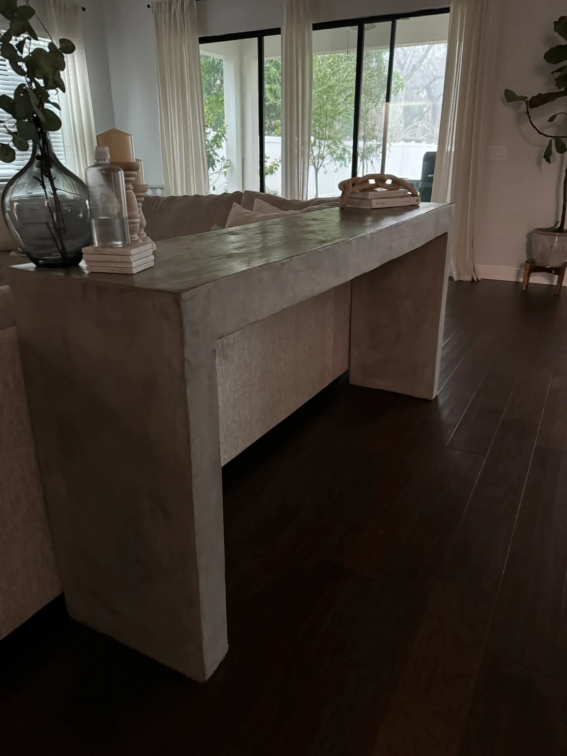 The finished hallway table, a pale concrete-finish console against a window