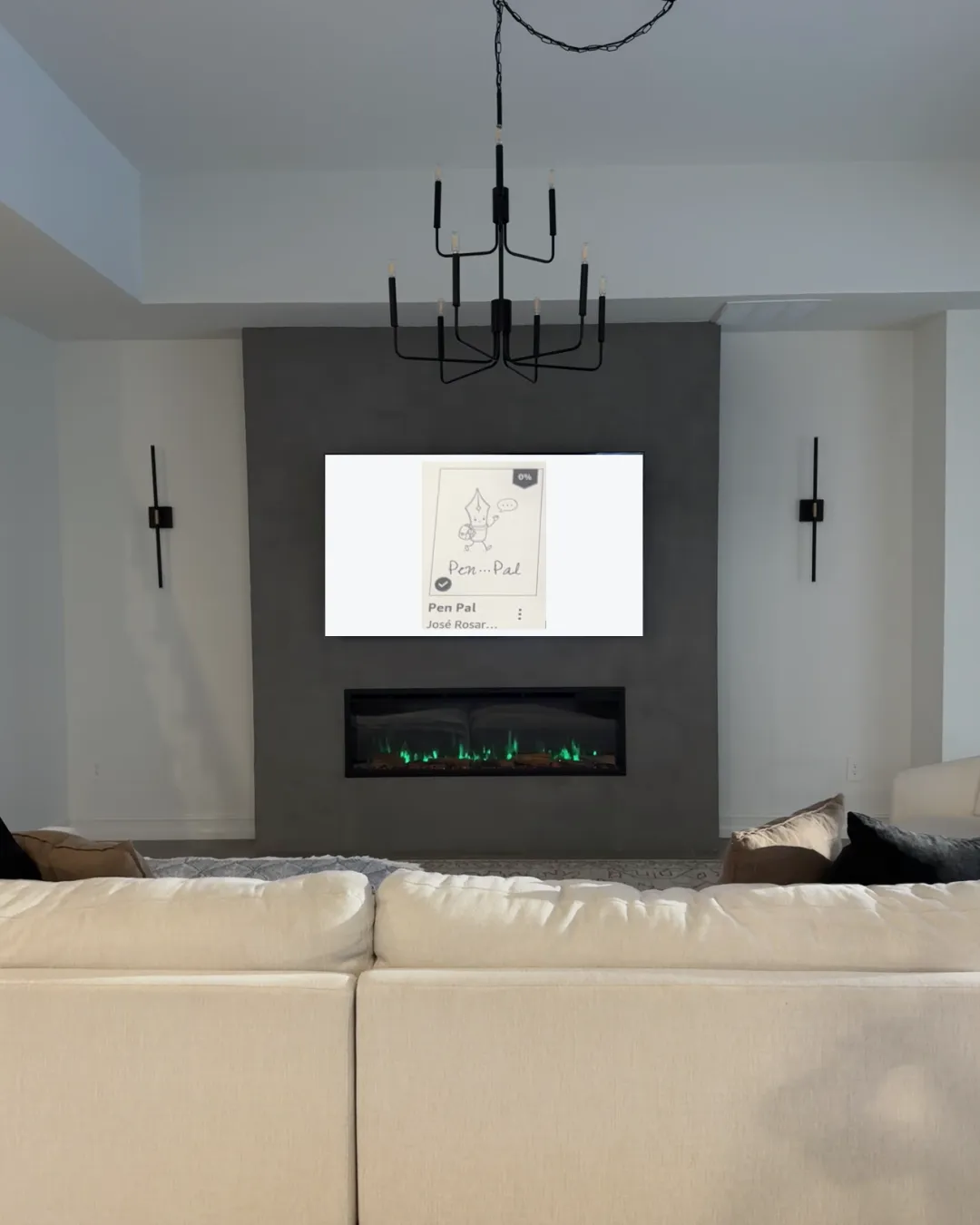A living-room wall finished in dark Venetian clay, holding a TV above a linear fireplace